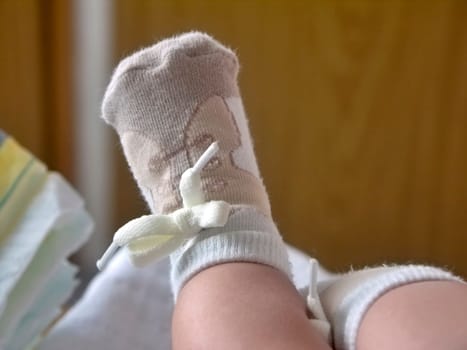 one childs foot in half-hose resembling shoes with shoelace