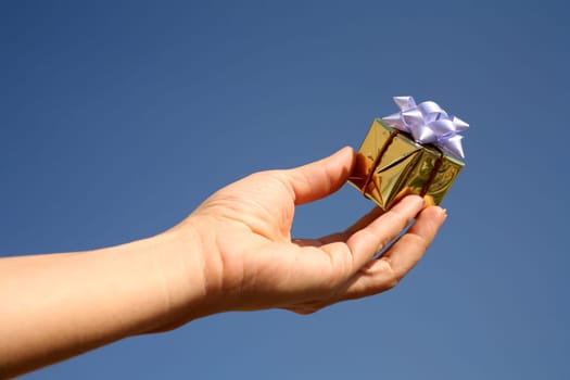 golden giftbox in hand