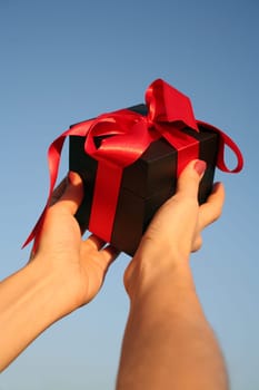 black giftbox in hand