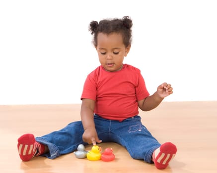 Girl playing with three ducks of plastic