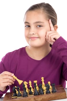 Attractive little girl playing chess