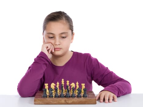 Attractive little girl playing chess
