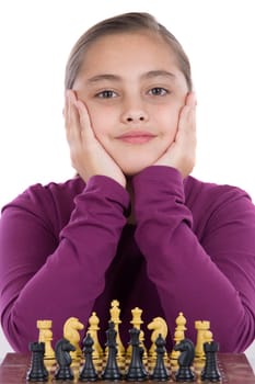 Attractive little girl playing chess