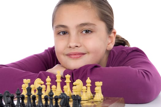 Attractive little girl playing chess