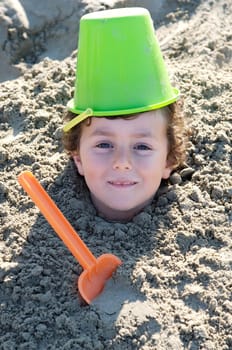 Child buried in the sand
