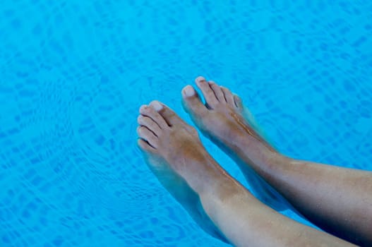 feet refreshing in swimming pool