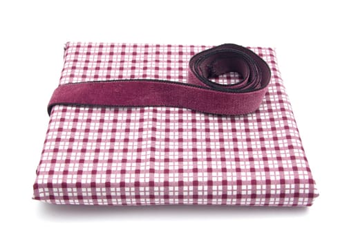 Purple ribbon on plaid fabric