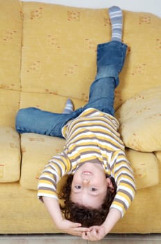 Boy lying down on the sofa at home