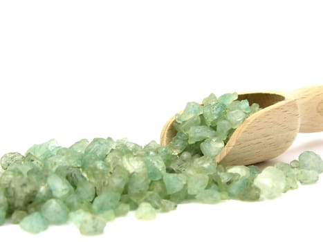 Green bath granules and a small wooden shovel