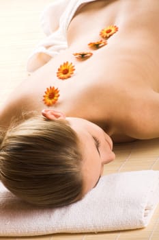Young woman with flowers on her back