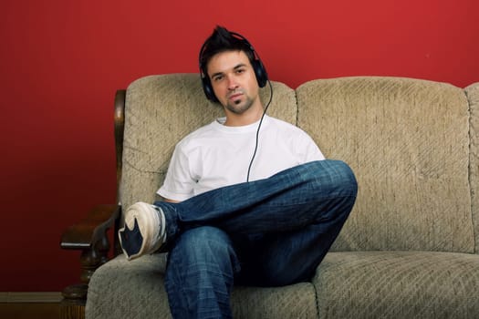 Sitting young man listening music