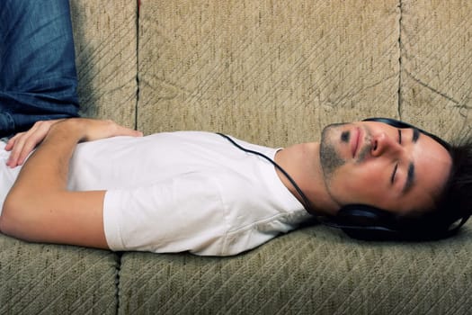 Laying young man listening music