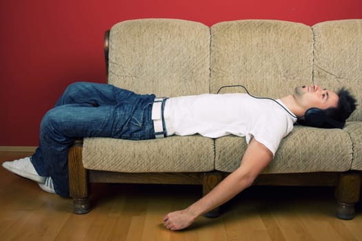 Laying young man listening music