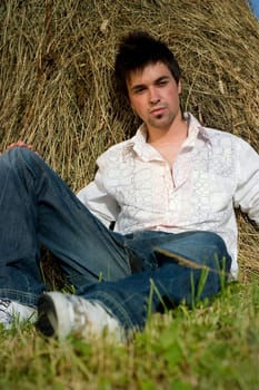 Young Man relaxing on the hay