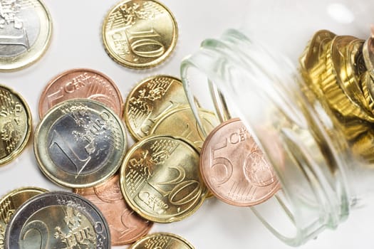 A jar with some small Euro coins inside