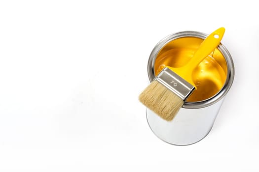 Yellow paint can with brush isolated
