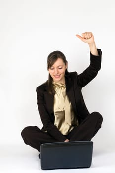 Young woman cheering in front of laptop