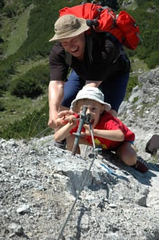Father and son climbing in the mountains