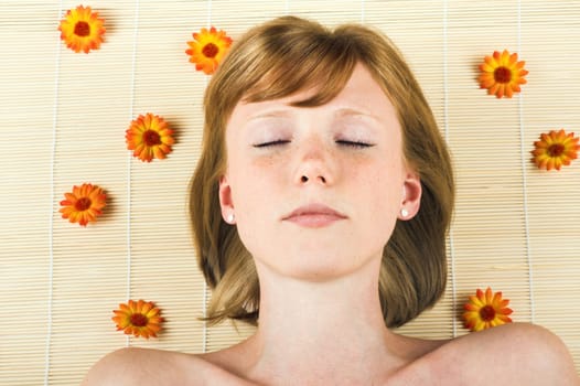 Relaxed woman at spa with flowers