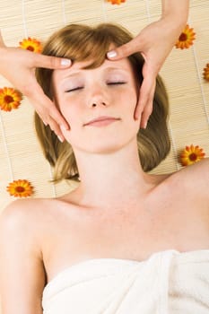 Relaxed woman at spa with flowers