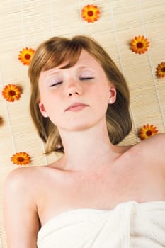 Relaxed woman at spa with flowers