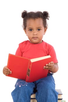 Baby reading sitting on a pile of books