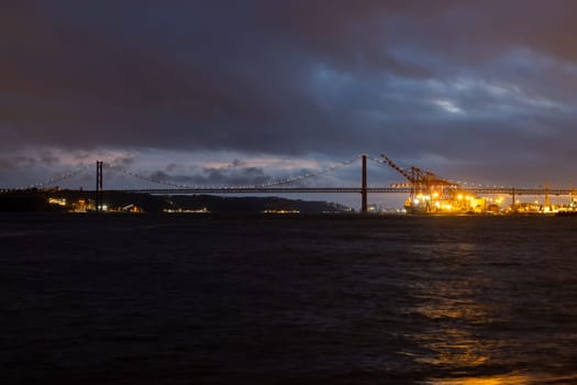 Night view of Tagus river and 25th of april bridge - Landscape. Mid shot