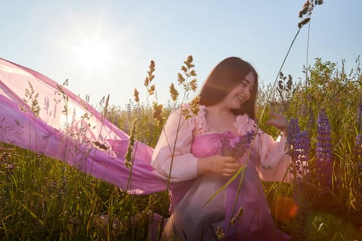 Young plump curvy beautiful teenage girl in a field or meadow on sunny summer day in the evening sunset sun. Plump black-haired and black-eyed oriental model from the east fairy tale