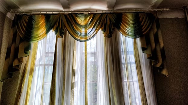 Beautiful curtain on the window and transparent tulle curtain. Abstract background, texture and pattern. Space for text and copy space