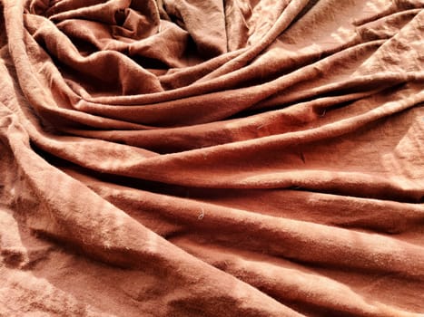 Abstract background and texture of crumpled brown fabric. Texture, pattern, frame and copy space