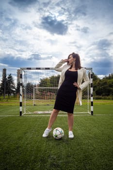 portrait of a beautiful woman football player in a strict office suit. concept sports office manager leisure