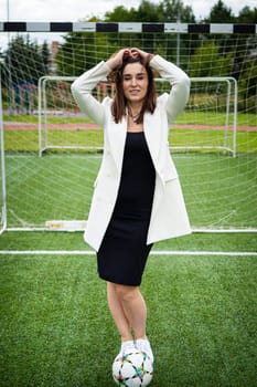 portrait of a beautiful woman football player in a strict office suit. concept sports office manager leisure