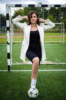 portrait of a beautiful woman football player in a strict office suit. concept sports office manager leisure