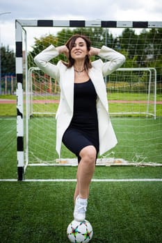 portrait of a beautiful woman football player in a strict office suit. concept sports office manager leisure