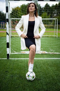 portrait of a beautiful woman football player in a strict office suit. concept sports office manager leisure