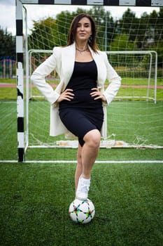 portrait of a beautiful woman football player in a strict office suit. concept sports office manager leisure