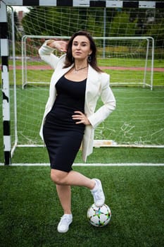 portrait of a beautiful woman football player in a strict office suit. concept sports office manager leisure