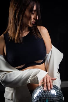 A business woman showing off her body in her underwear. Shot in the studio on a dark background.