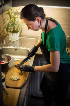 Woman cooking tasty melted chocolate on table in kitchen. Delicious dessert made of homemade chocolate.