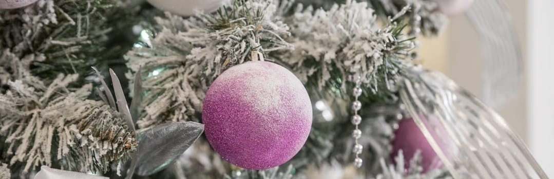 Beautiful decorated Christmas tree and pink boxes with gifts