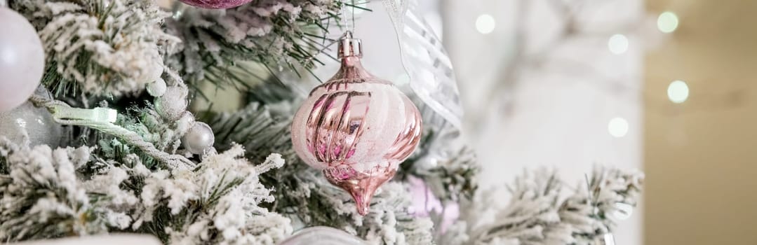 Beautiful decorated Christmas tree and pink boxes with gifts