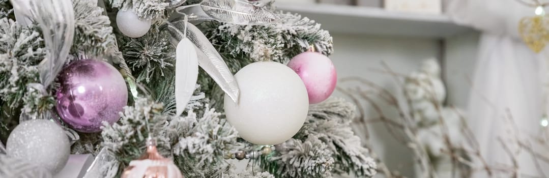 Beautiful decorated Christmas tree and pink boxes with gifts