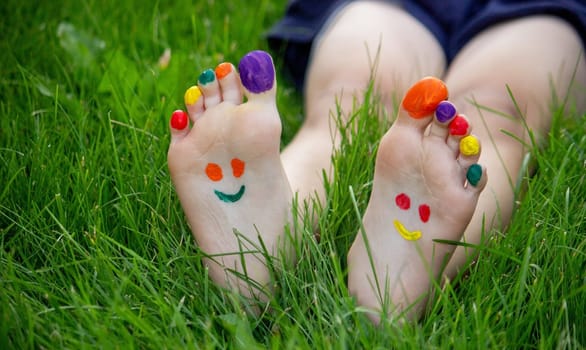 a smile painted with paints on the child's arms and legs. Selective focus