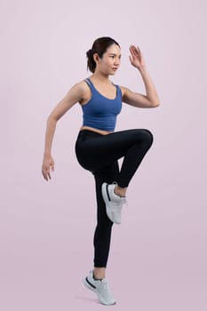 Side view young athletic asian woman on running posture in studio shot on isolated background. Pursuit of healthy fit body physique and cardio workout exercise lifestyle concept. Vigorous