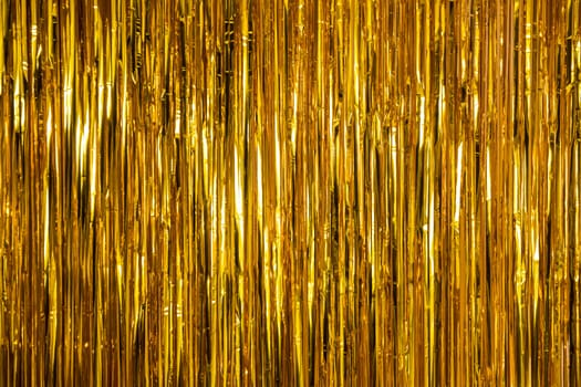 Metallic gold foil tinsel fringe decoration curtain. Birthday, wedding, Christmas, New Year party decoration background
