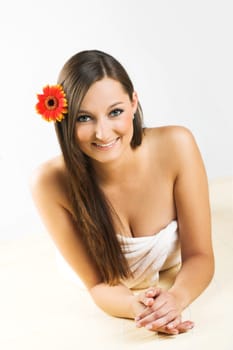 Happy woman at spa with flower
