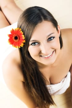 Happy woman at spa with flower