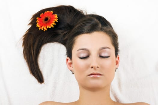 Relaxed woman at spa with flower