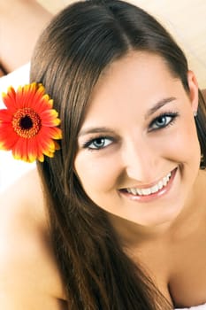 Happy woman at spa with flower