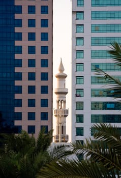 Minaret peeping between office buildings